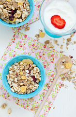 granola and yogurt with strawberries on a table