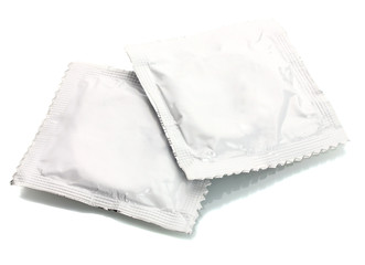 Two condoms isolated on white