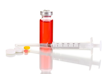 Syringe with medical ampoule and tablets isolated on white