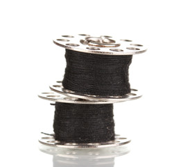 Metal spools of thread isolated on white