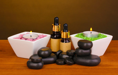 Spa setting on wooden table on brown background