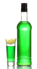 bottle and glass of absinthe with lime isolated on white