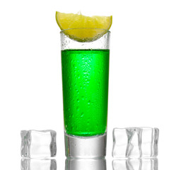 glass of absinthe, ice and lime isolated on white