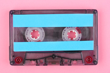Audio cassette with color label on pink background