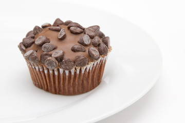 Chocolate chip cup cake on white plate