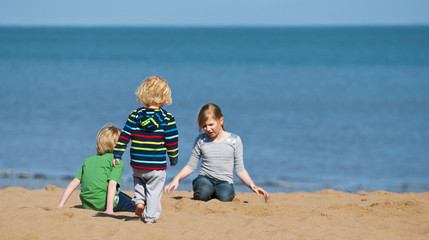 Fototapeta na wymiar Children playing on the beach