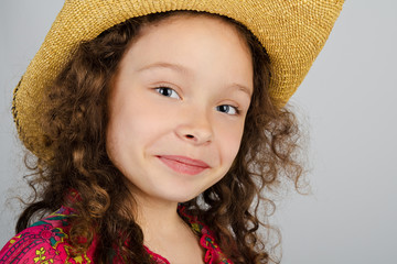 Portrait of smiling little girl in the hat