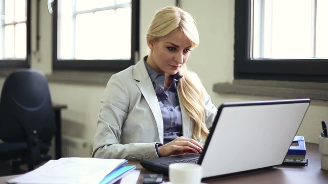 Businesswoman finishing work on laptop and relaxing