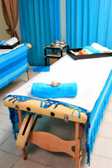 Fototapeta na wymiar blue towels and part of massage table.