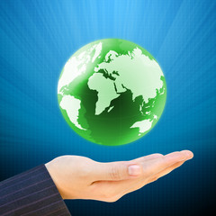 holding a earth globe in hand on blue background