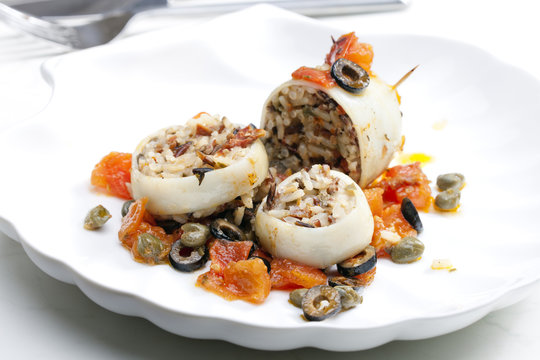 baked sepia with tomatoes and black olives filled with pearl bar