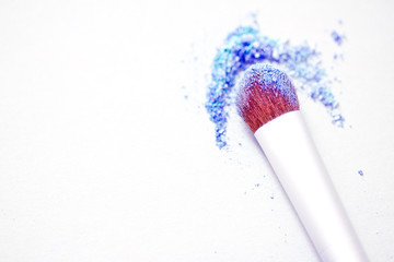 blue eyeshadow make-up powder and brush with shallow dof