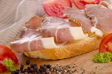 ham sandwich on a wooden board