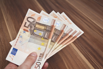 Hand hält 50-Euro-Scheine