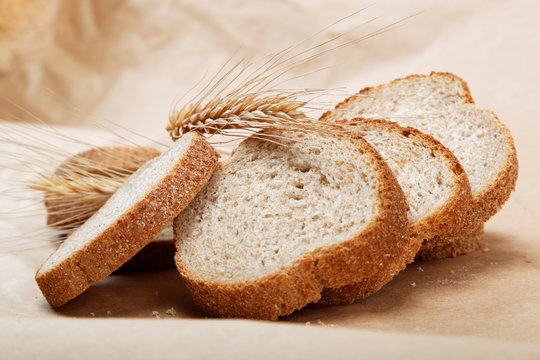 Fresh bread isolated on a light brown background.