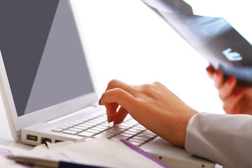 Close-up of businesswoman typing documents on keyboard