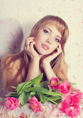 Fototapeta na wymiar Picture of happy young blonde woman with colorful flowers