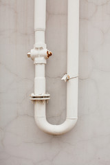 Old rusty pipes against a wall