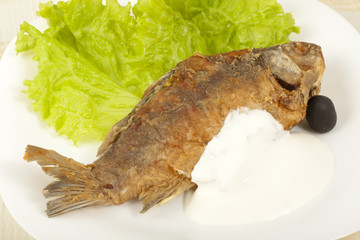 Fish fried carp with sour cream