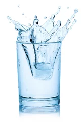 Gordijnen Splash from ice cube in a glass of water. © Juri