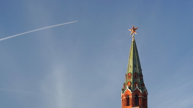 Jet airplane over Moscow Kremlin tower