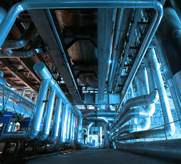 Equipment, cables and piping as found inside of a modern industr