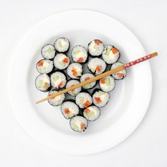 Sushi on a plate in the shape of heart