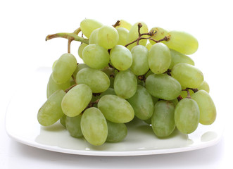 Green grapes on white plate