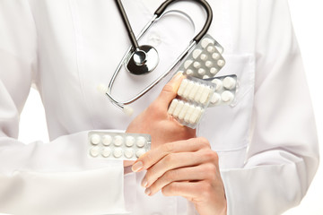 Doctor holding many pills