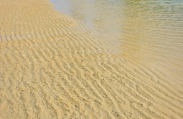 Beach wet sand ripple pattern background.