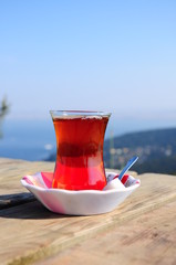 a glass of black (red) tea  on table