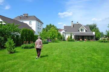 senior woman on garden of her house