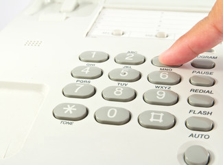 One human hand pressing key on phone