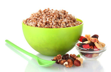 Boiled buckwheat in a green bowl isolated on white