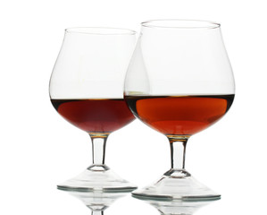 Two glasses of cognac isolated on white