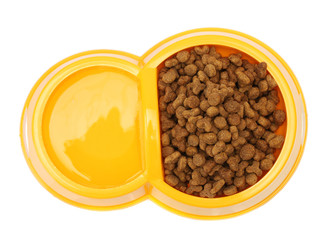 dry cat food and water in yellow bowl isolated on white