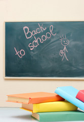 School books and the desk. Back to school.