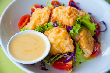 Delicious salad with fish, vegetable and dipping sauce