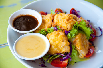 Delicious salad with fish, vegetable and dipping sauce