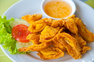 Deep Fried Wonton on white dish with plum sauce