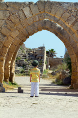 Little boy walks in Caesarea. Israel