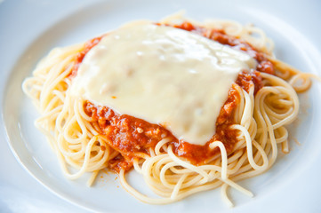 tasty spaghetti with cream, cheese and parsley close up