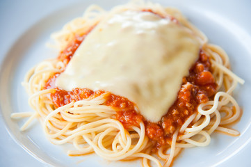 tasty spaghetti with cream, cheese and parsley close up