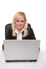 Smiling secretary at her laptop