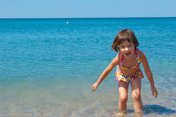 Family summer beach vacation. Happy active child having fun
