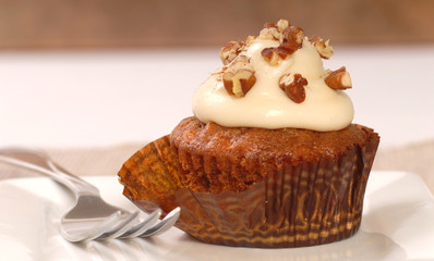 Delicious carrot cake cupcake with cream cheese frosting and nut