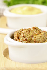 French mustard sauce in white gravy boat