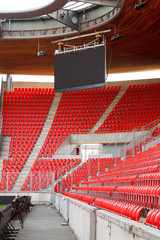 Corner of an empty football stadium with projection screen