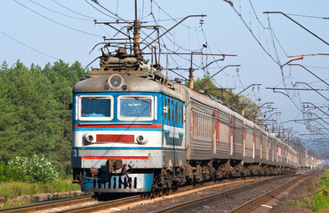Fototapeta premium Passenger train hauled by electric locomotive