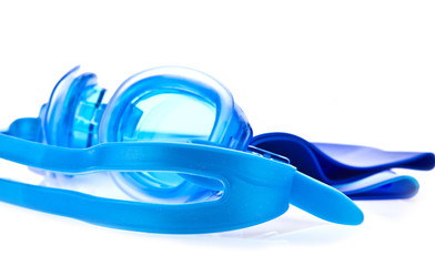 Blue swimming goggles and cap on white background